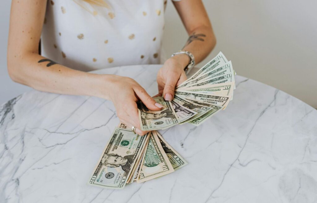 Person Holding US Dollar Bills